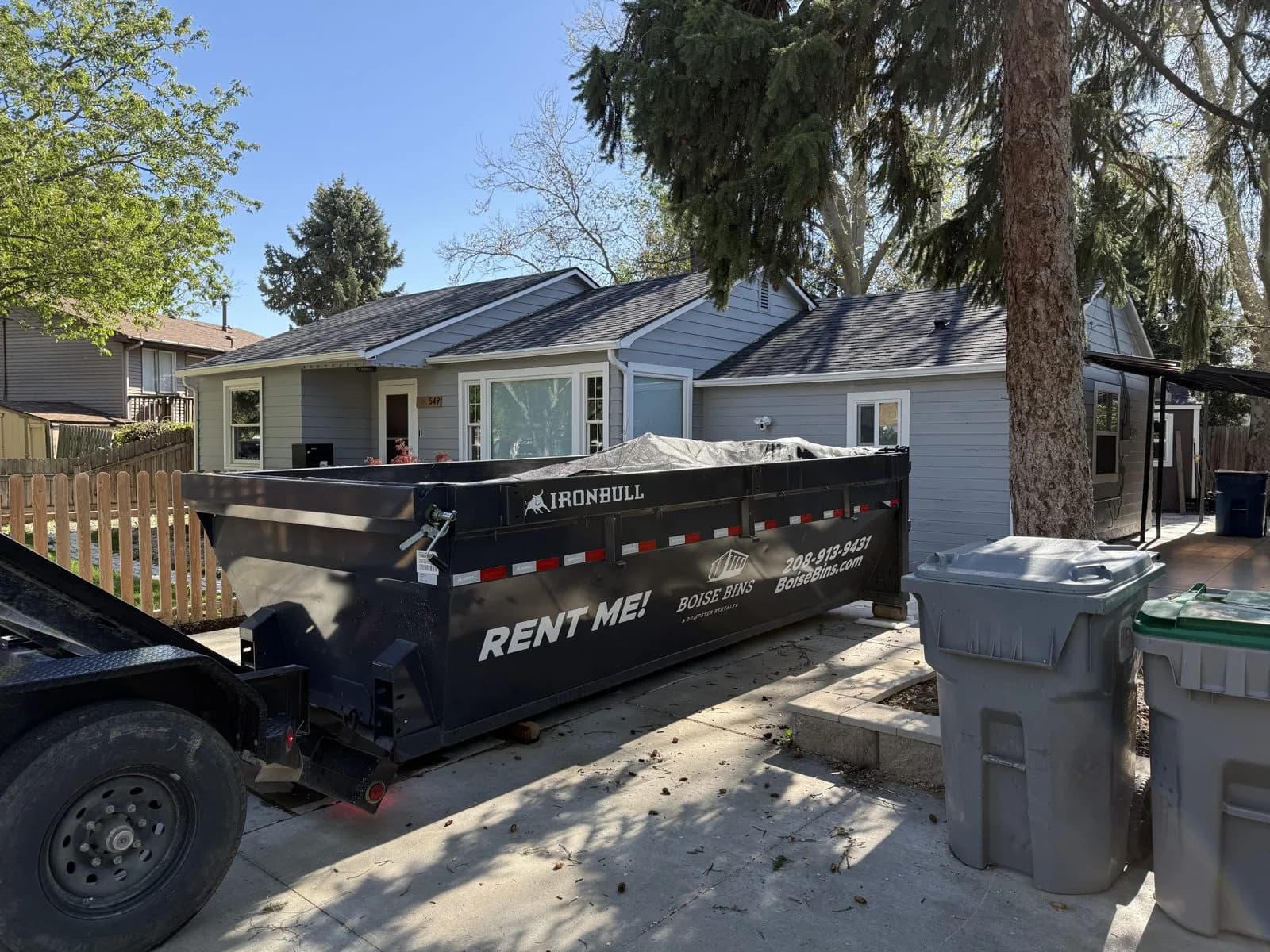 15 yard roll-off dumpster loaded on the delivery trailer in Boise, ID - Boise Bins